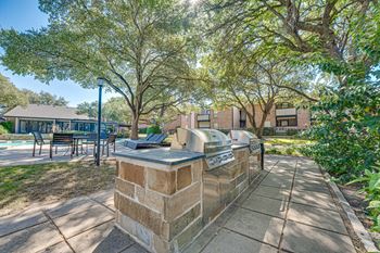 Planter on top is in the middle of a paved walkway